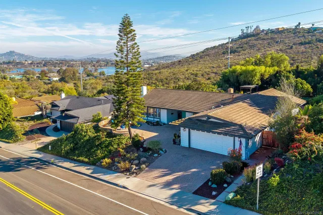 an aerial view of multiple houses with a yard