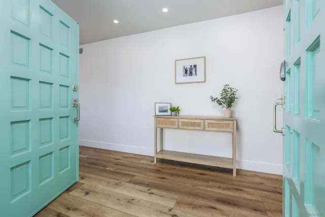 a view of an entryway with wooden floor