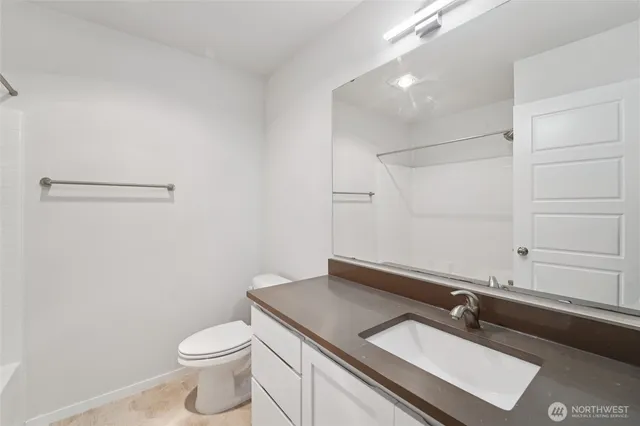 a view of a hallway with closet and wooden floor
