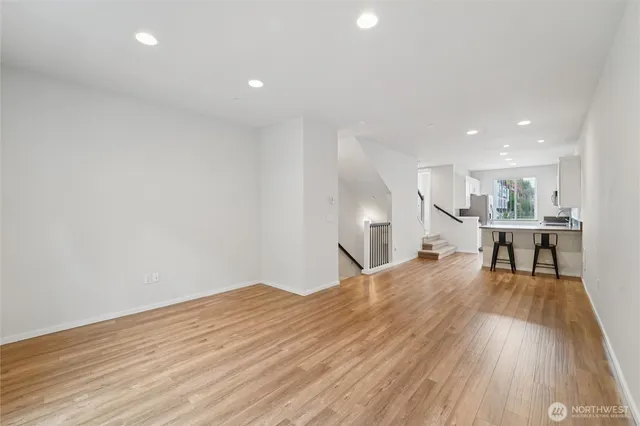 a view of a kitchen with wooden floor and furniture