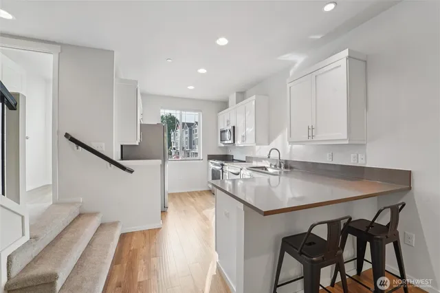 a kitchen with a table chairs stove and cabinets
