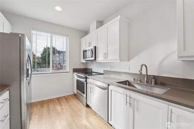 a kitchen with a sink stove and cabinets