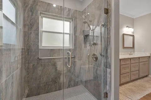 a bathroom with a shower and a sink