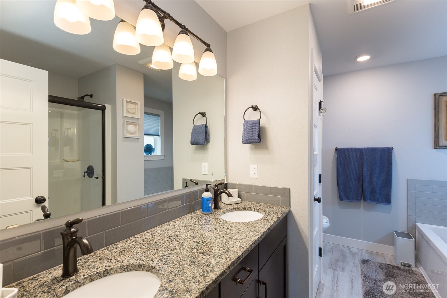 41 Victoria View Street Sequim, WA 98382 - Photo 14 of 40 a bathroom with a granite countertop sink and a mirror