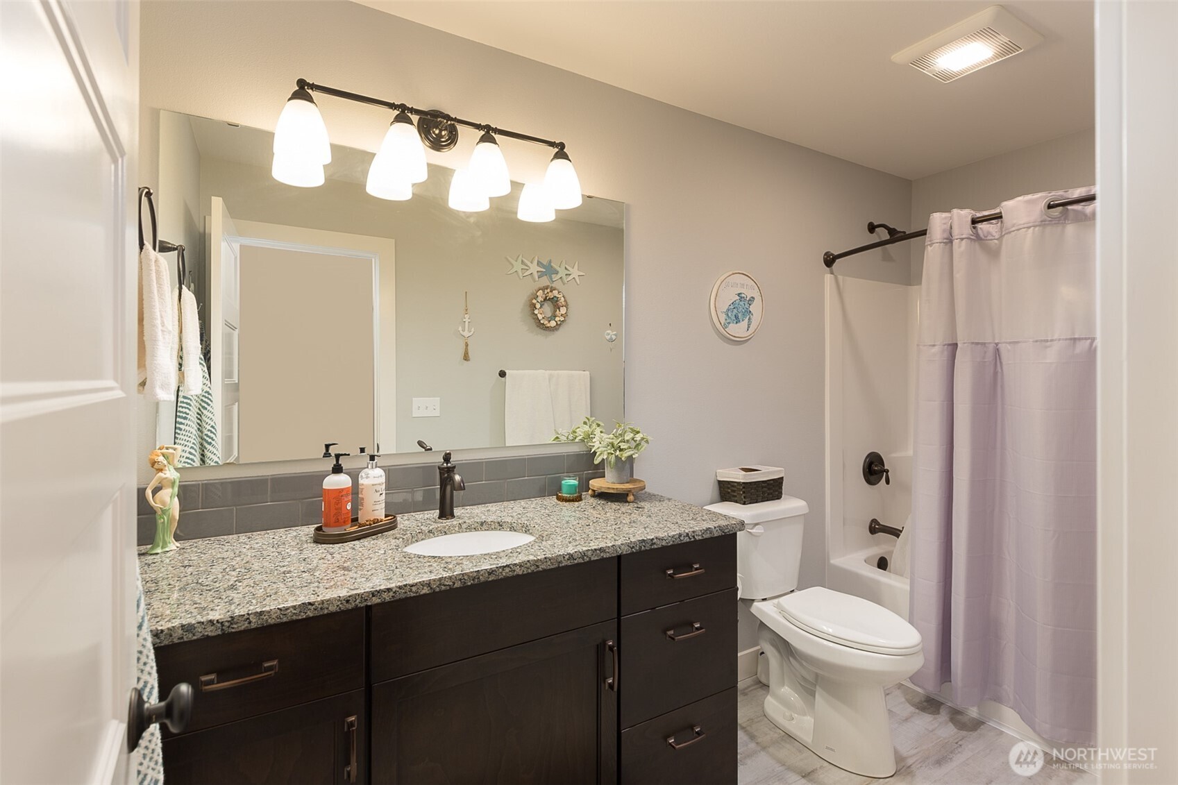 41 Victoria View Street Sequim, WA 98382 - Photo 20 of 40 a bathroom with a granite countertop sink toilet mirror and shower
