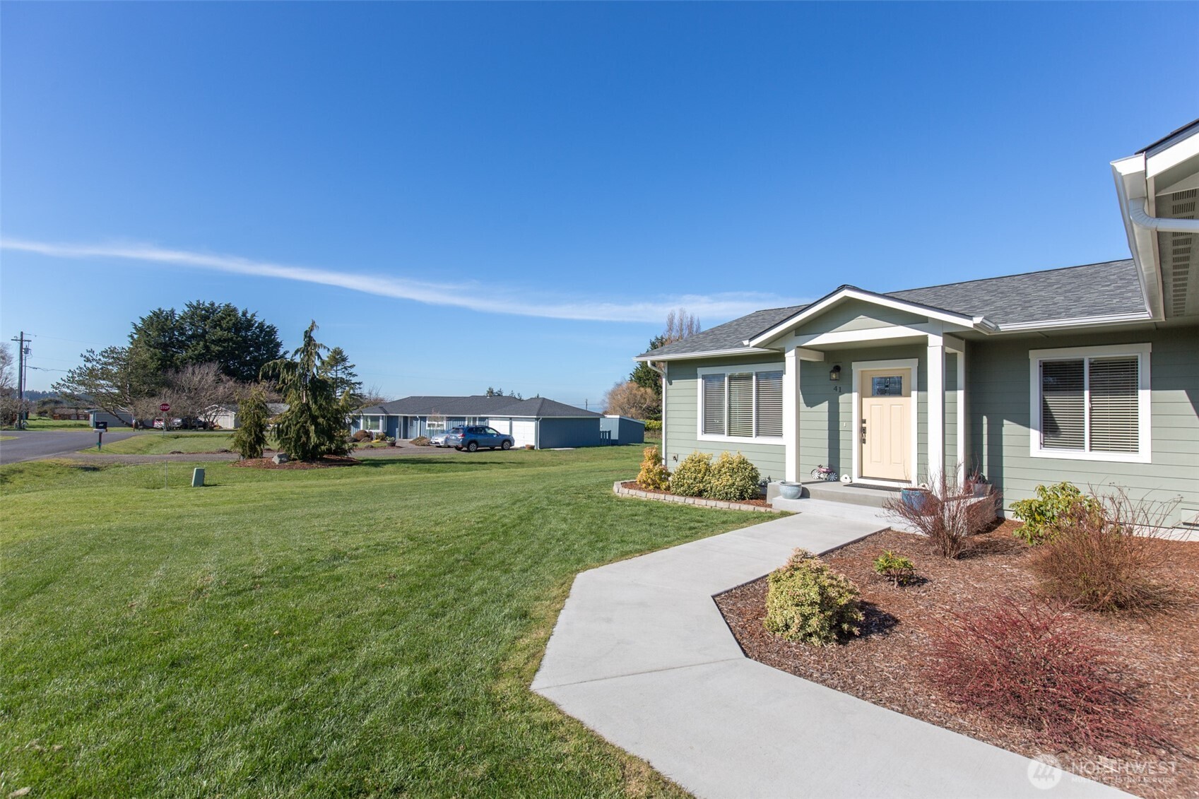 41 Victoria View Street Sequim, WA 98382 - Photo 2 of 40 a front view of a house with a garden
