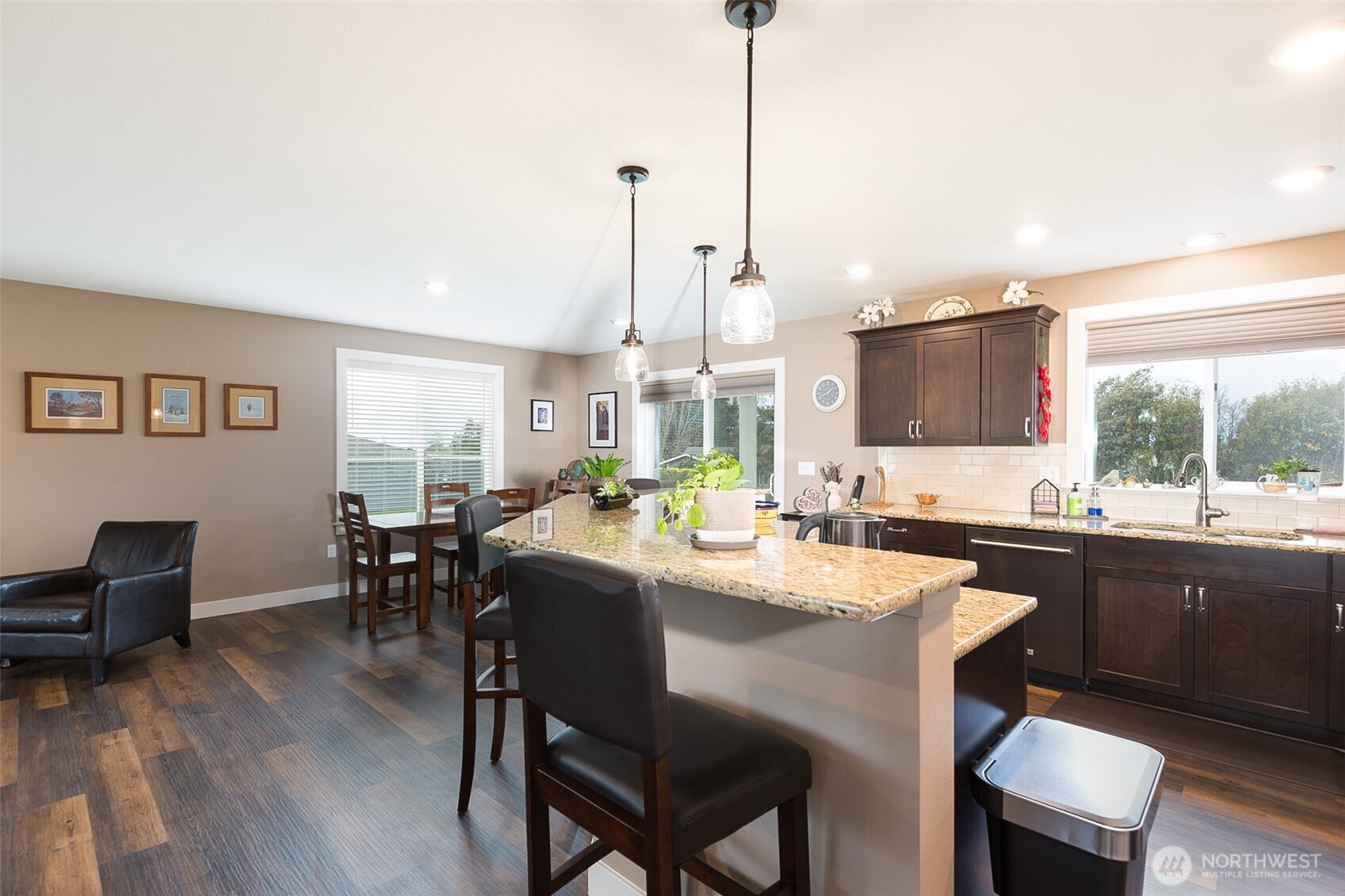 41 Victoria View Street Sequim, WA 98382 - Photo 10 of 40 a kitchen with kitchen island granite countertop a sink a stove a dining table and chairs