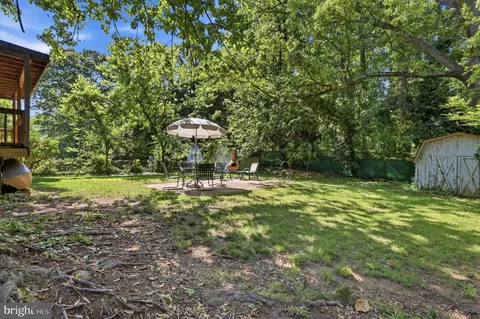 a view of a house with a big yard and potted plants