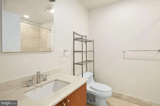 a bathroom with a sink toilet and mirror