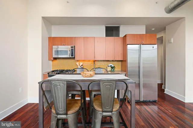 a view of a kitchen area with furniture and wooden floor