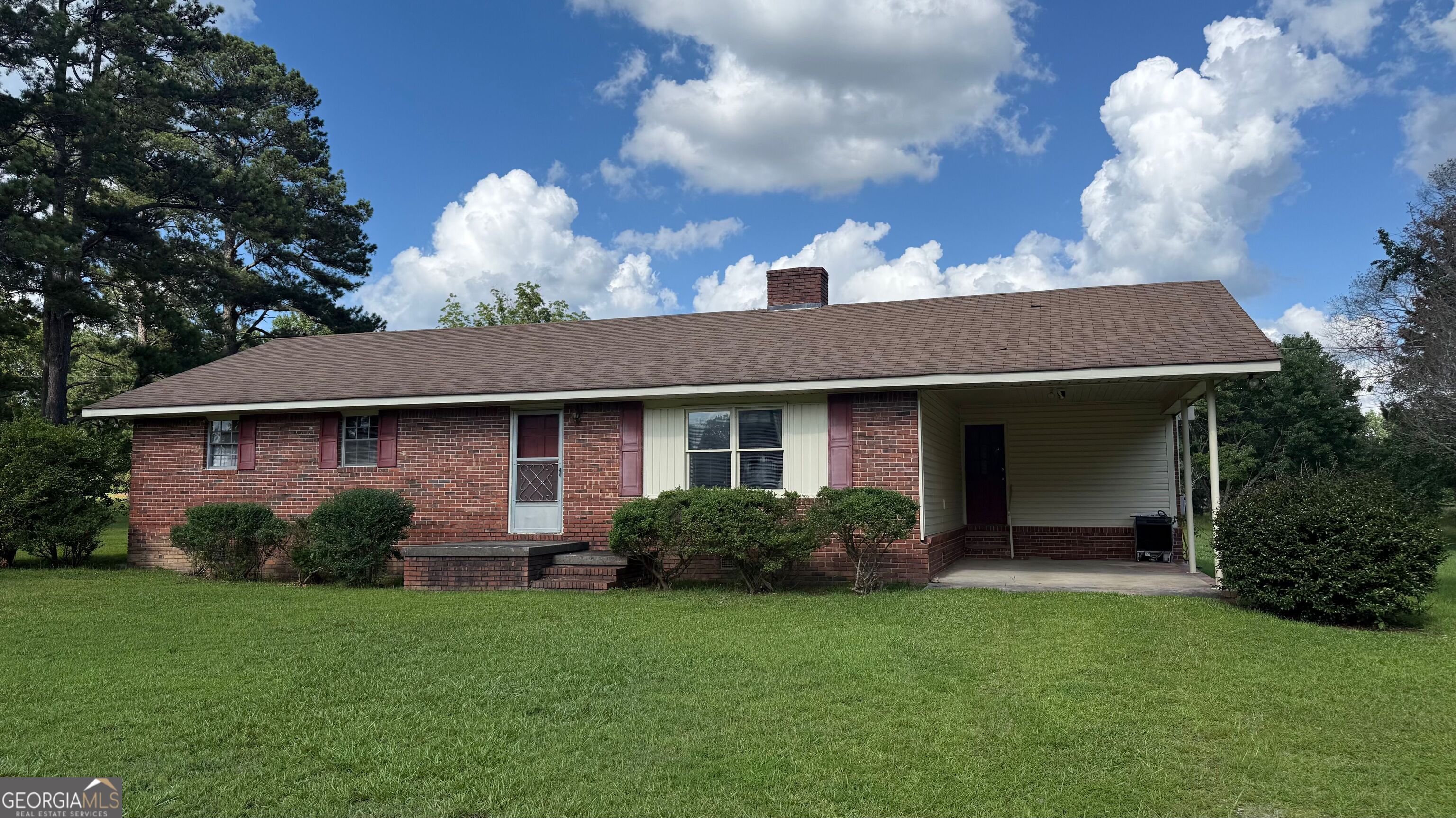 350 Waller Road Thomaston, GA 30286 - Photo 1 of 1 a view of a house with brick walls and a yard with potted plants