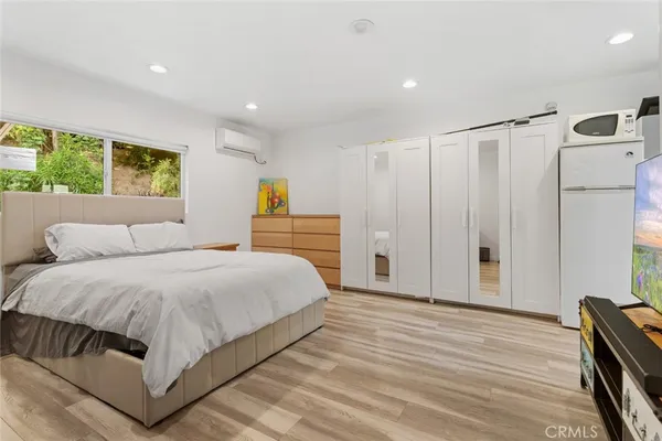 a spacious bedroom with a bed and a cabinets