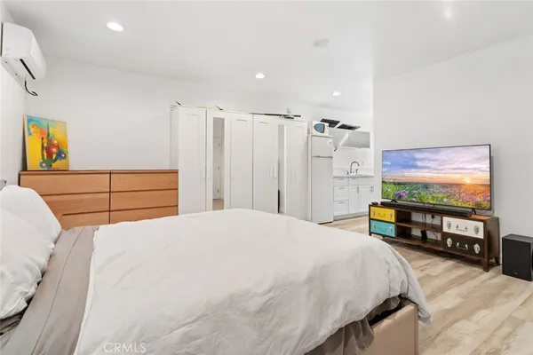 a bedroom with a bed and a flat screen tv