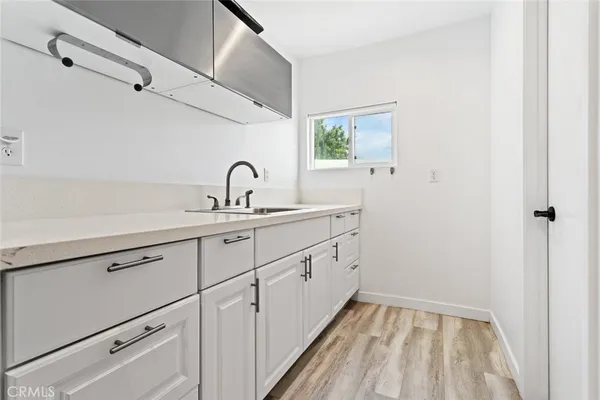 a kitchen with a sink and a mirror
