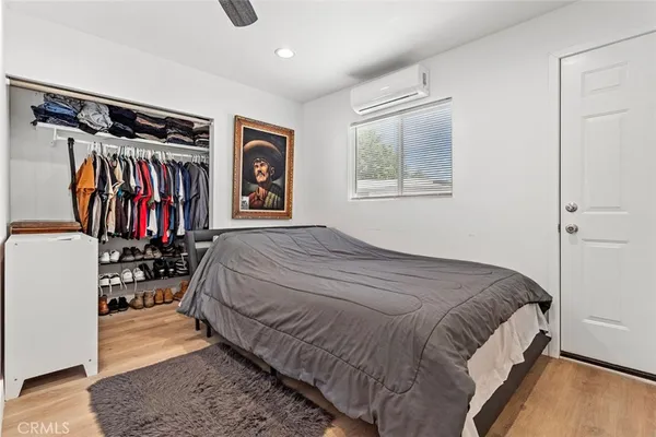 a bedroom with a large bed and a window