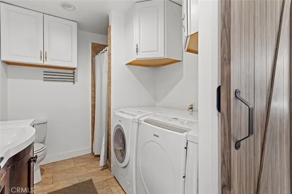 a view of a storage and utility room with washer and dryer