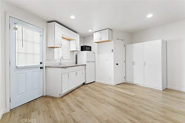 a view of a kitchen with electric appliances