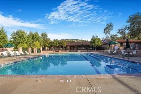 a view of a swimming pool with an outdoor seating