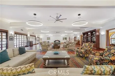 a living room with lots of white furniture and a large window