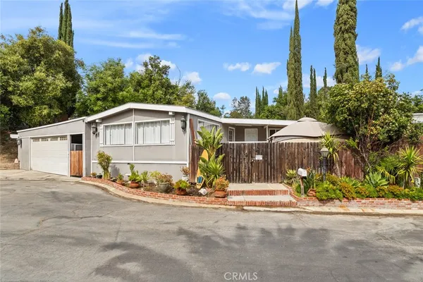 a view of a house with many windows next to a road