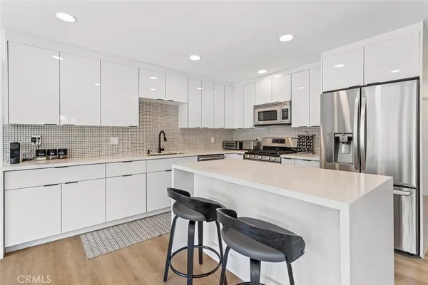 a kitchen with stainless steel appliances a refrigerator stove microwave and cabinets