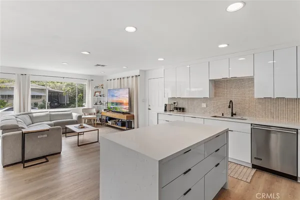 a kitchen with lots of counter top space and living room