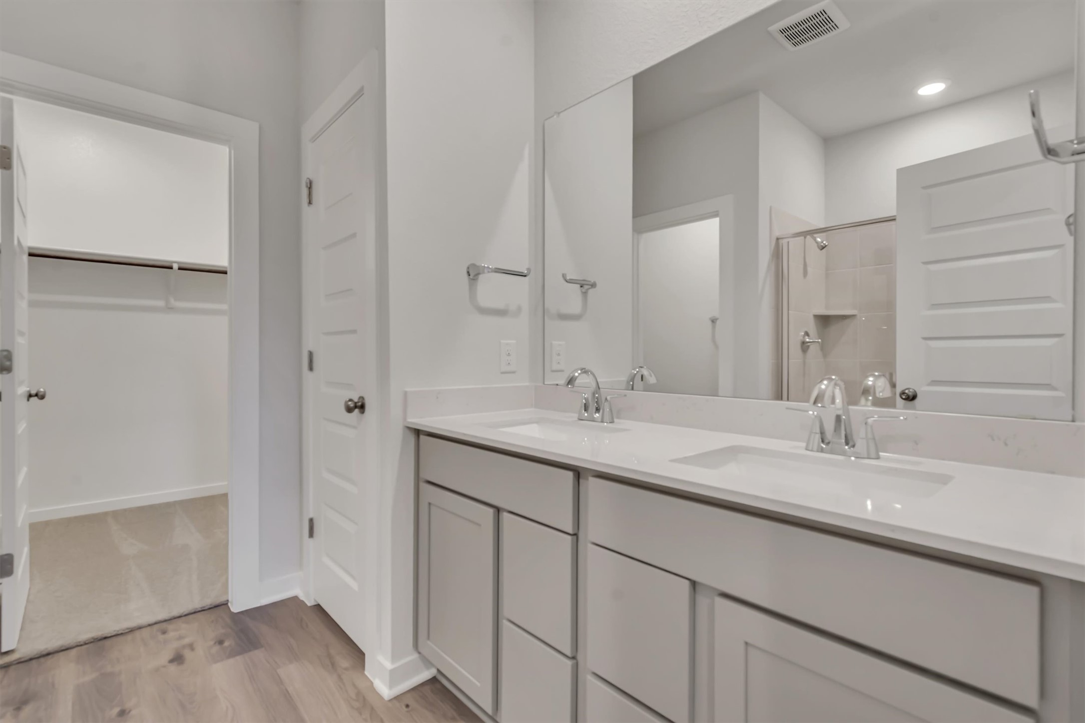 212 Bendecido Loop Elgin, TX 78621 - Photo 12 of 16 Double vanity and a spacious walk-in closet highlight this contemporary bathroom.
