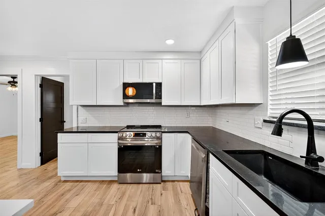 a view of a closet area with wooden floor