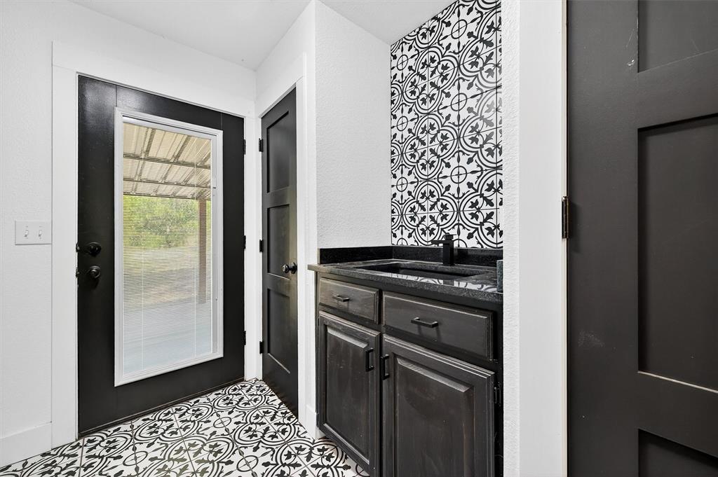621 Craft Road Bells, TX 75414 - Photo 17 of 40 a kitchen with a refrigerator and a sink
