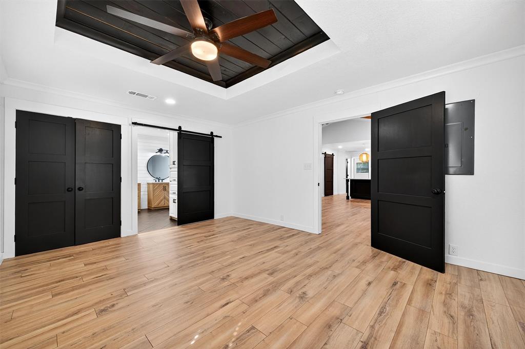 621 Craft Road Bells, TX 75414 - Photo 19 of 40 a view of an empty room with wooden floor and a ceiling fan