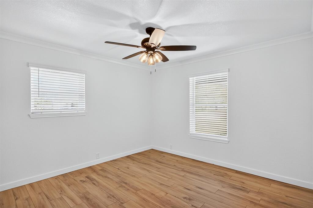 621 Craft Road Bells, TX 75414 - Photo 24 of 40 a view of a room with wooden floor ceiling fan and windows