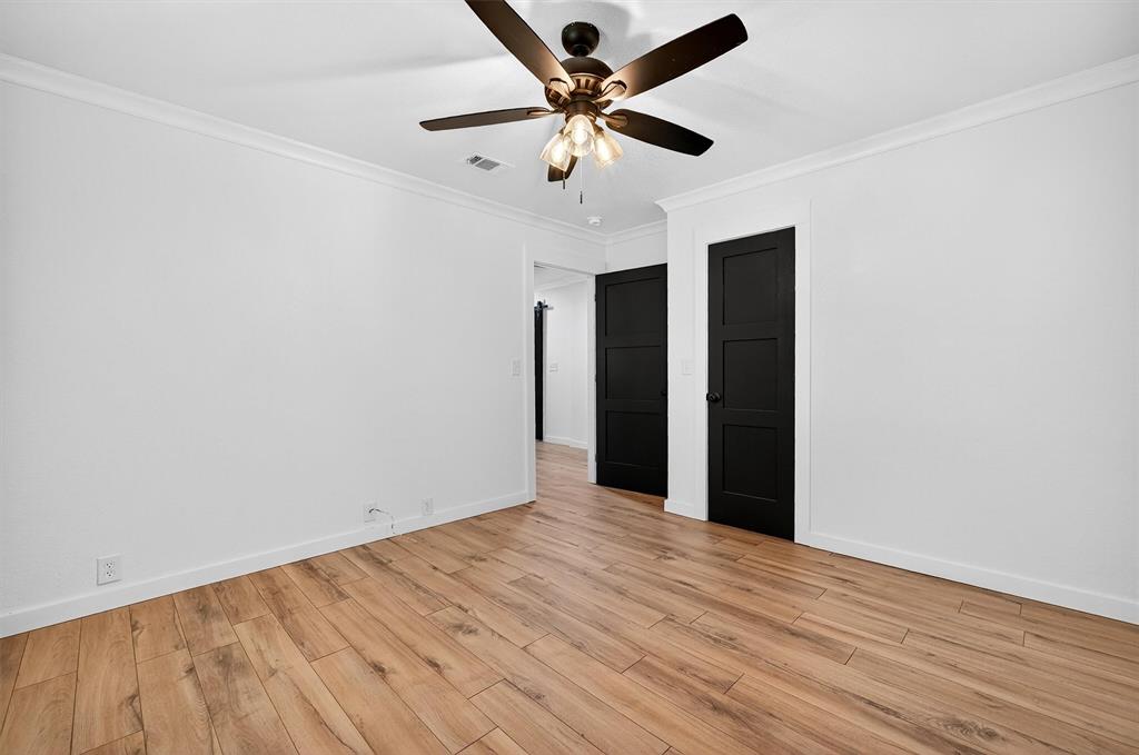621 Craft Road Bells, TX 75414 - Photo 25 of 40 an empty room with wooden floor and ceiling fan