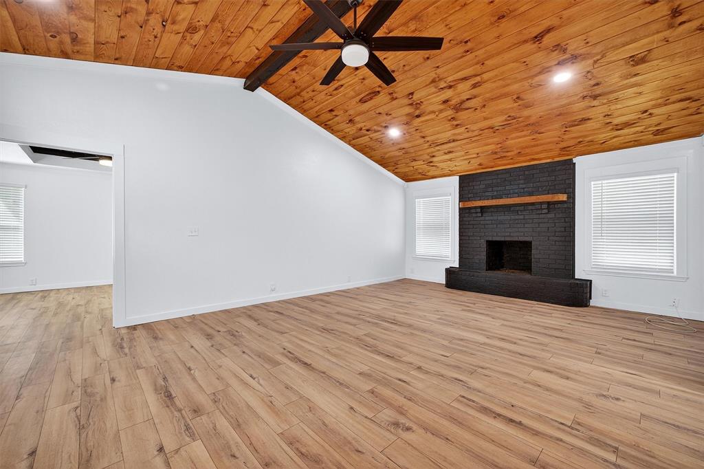 621 Craft Road Bells, TX 75414 - Photo 9 of 40 a view of empty room with wooden floor and fireplace