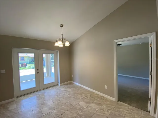 an empty room with fan and entrance