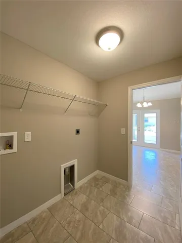a view of a room with wooden floor and white walls