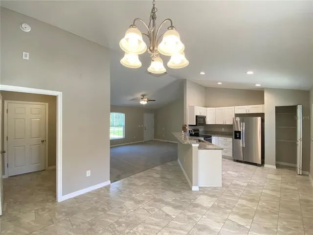 a view of a kitchen with a sink and a refrigerator