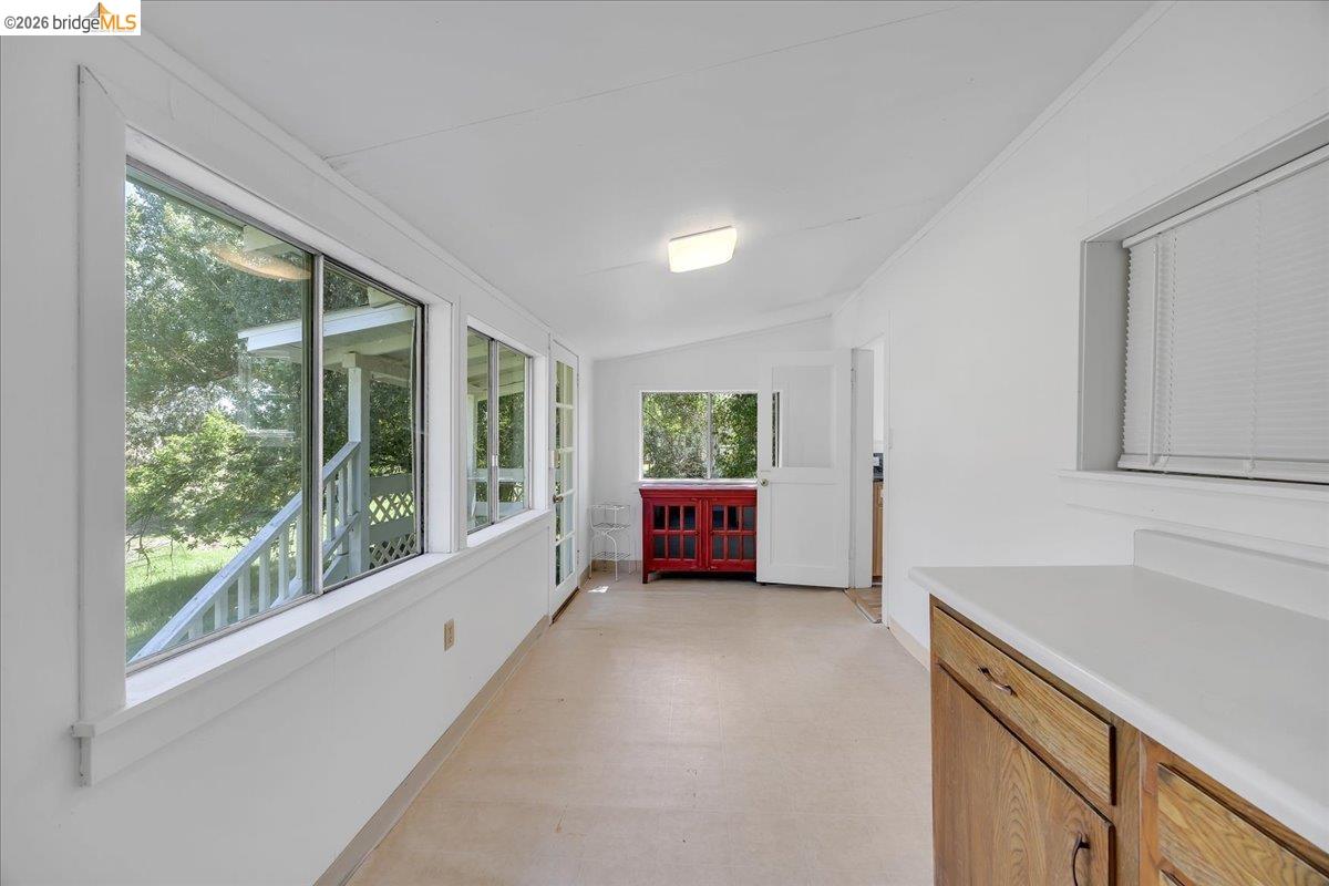 10624 Campo Seco Road Jamestown, CA 95327 - Photo 18 of 46 a view of an empty room with a window and kitchen view