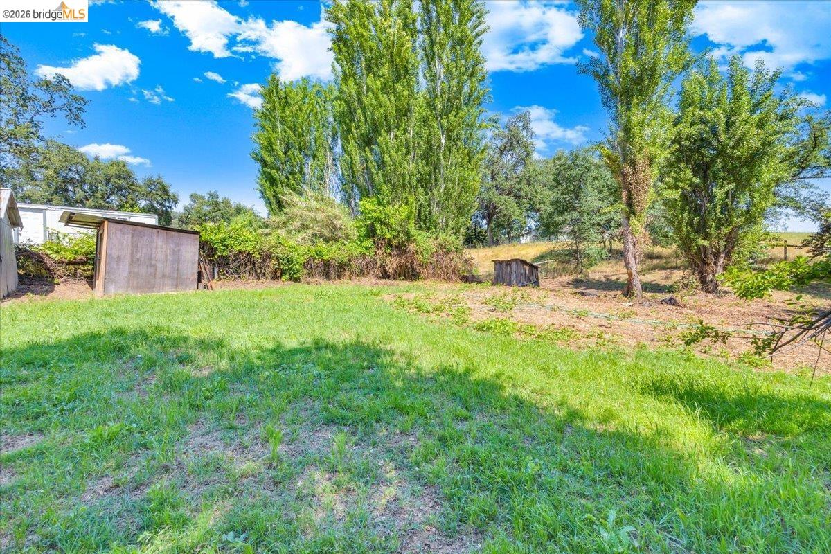 10624 Campo Seco Road Jamestown, CA 95327 - Photo 42 of 46 a view of a backyard with table and chairs and wooden fence