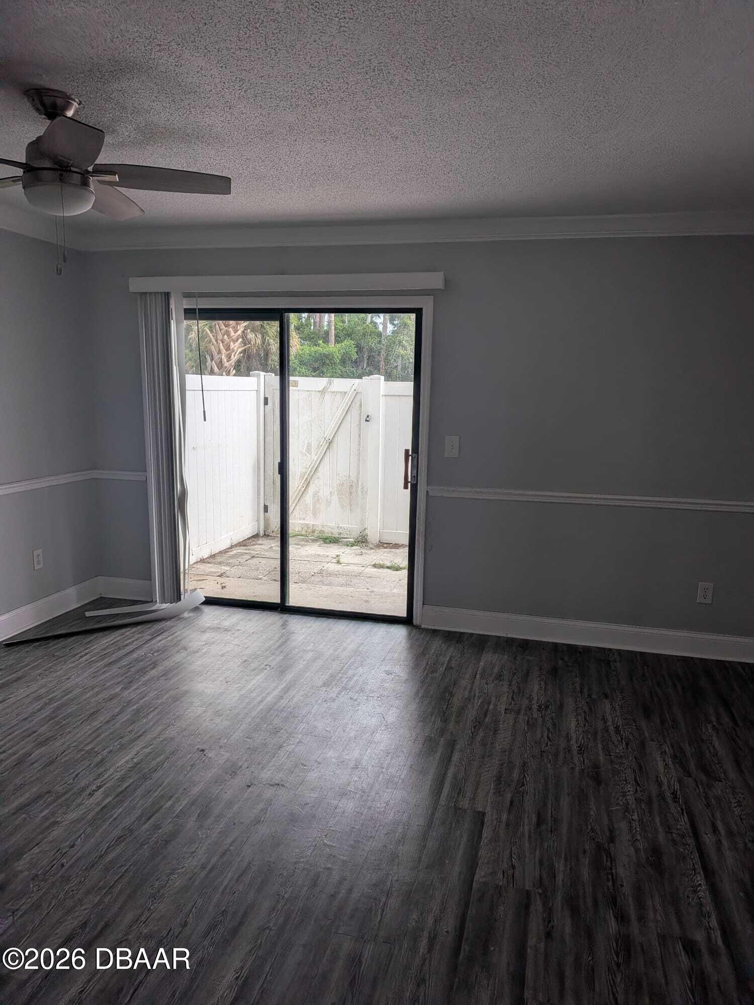 480 Reed Canal Road, Unit 57 South Daytona, FL 32119 - Photo 2 of 10 an empty room with wooden floor and windows
