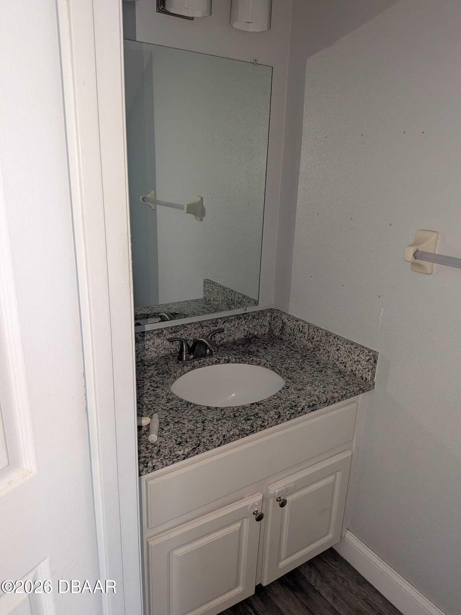 480 Reed Canal Road, Unit 57 South Daytona, FL 32119 - Photo 7 of 10 a bathroom with a granite countertop sink and a mirror