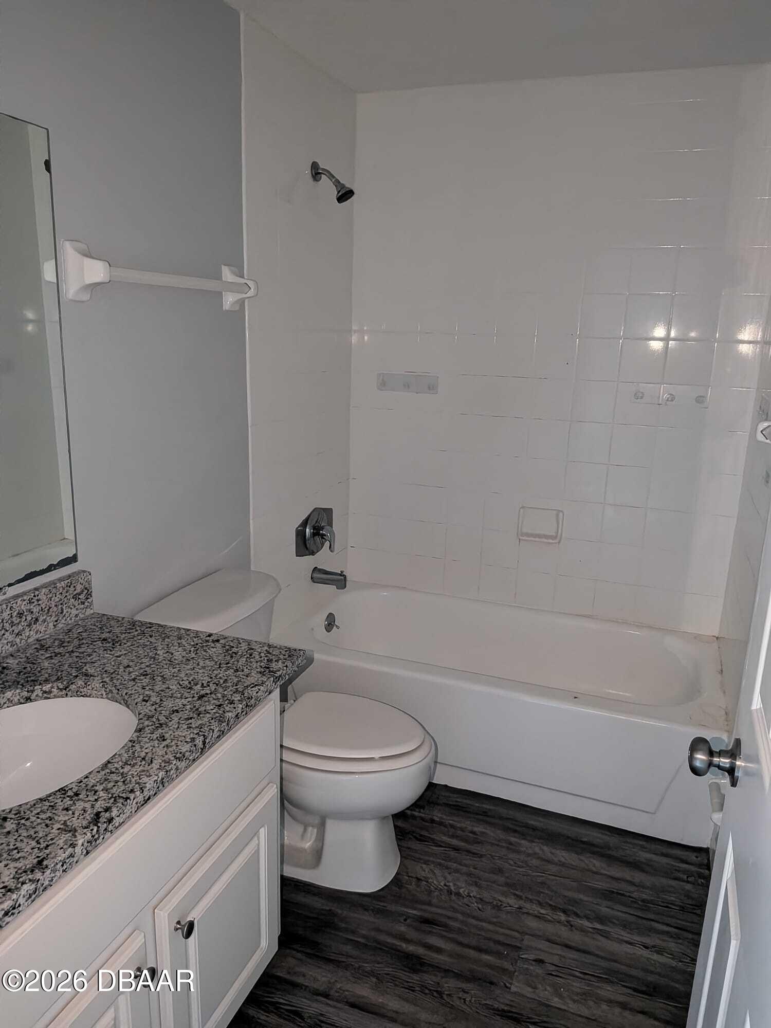 480 Reed Canal Road, Unit 57 South Daytona, FL 32119 - Photo 8 of 10 a bathroom with a granite countertop toilet a sink and bathtub