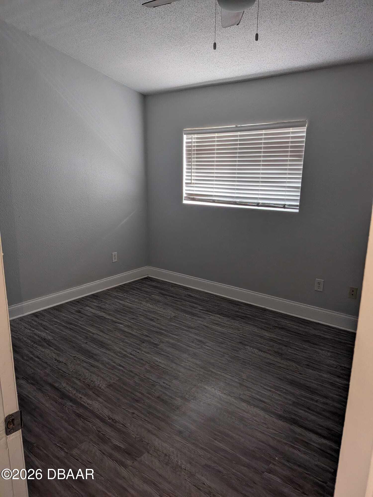 480 Reed Canal Road, Unit 57 South Daytona, FL 32119 - Photo 10 of 10 a view of an empty room with wooden floor and a window