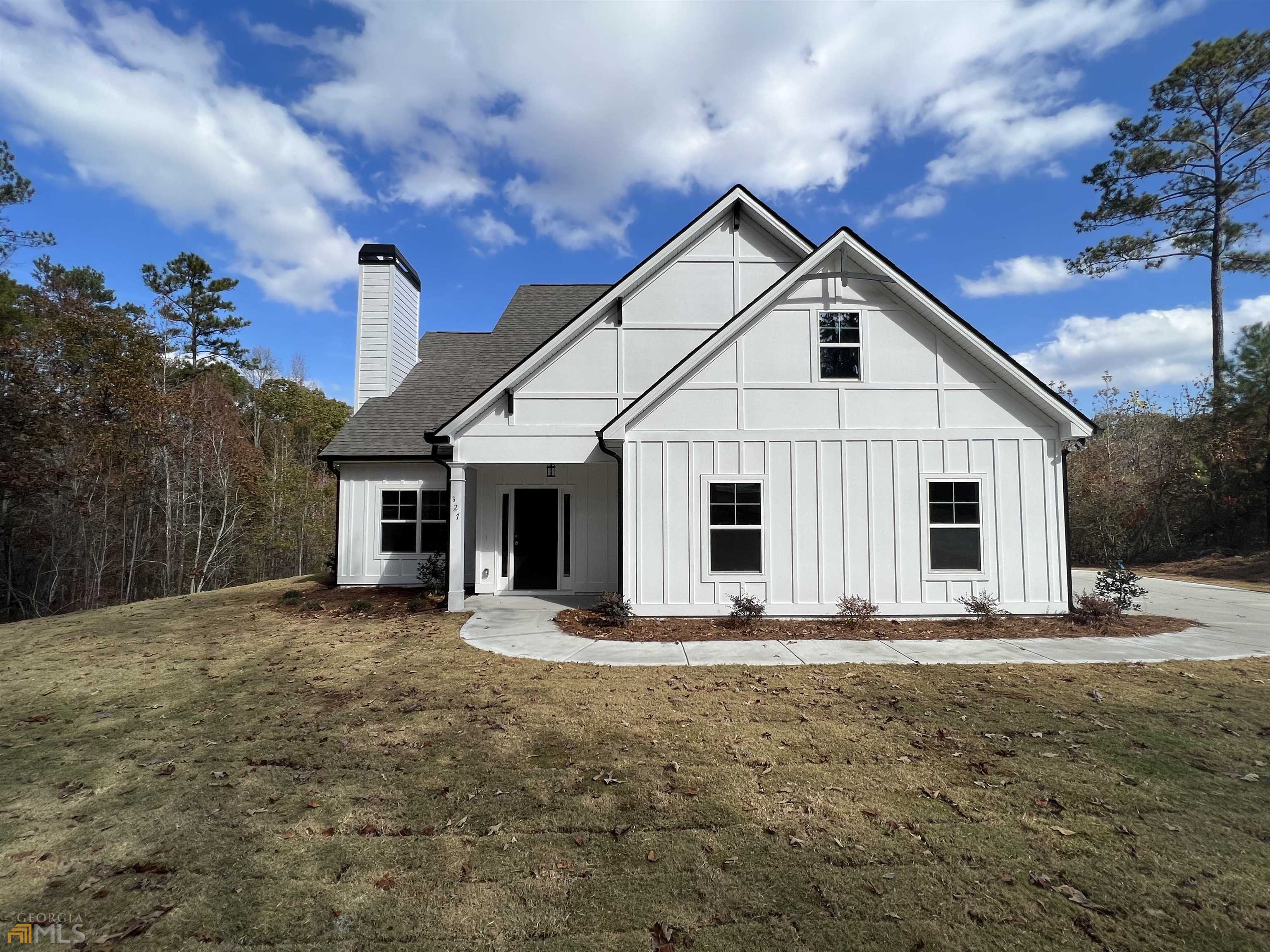 327 Walt Carmichael Road, Unit 3 Newnan, GA 30263 - Photo 1 of 1 a front view of a house with a yard