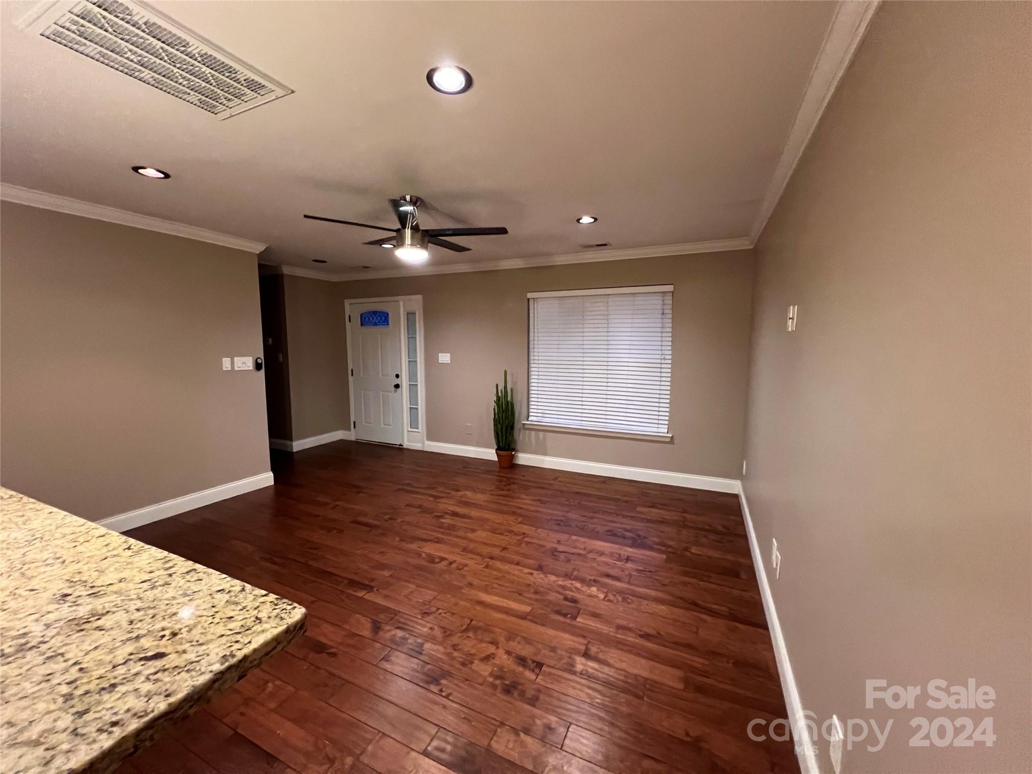 12228 Lullingstone Road Pineville, NC 28134 - Photo 8 of 41 wooden floor in an empty room with a window