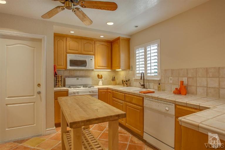 2283 Ralston Street Simi Valley, CA 93063 - Photo 8 of 37 a kitchen with a sink a stove cabinets and counter space