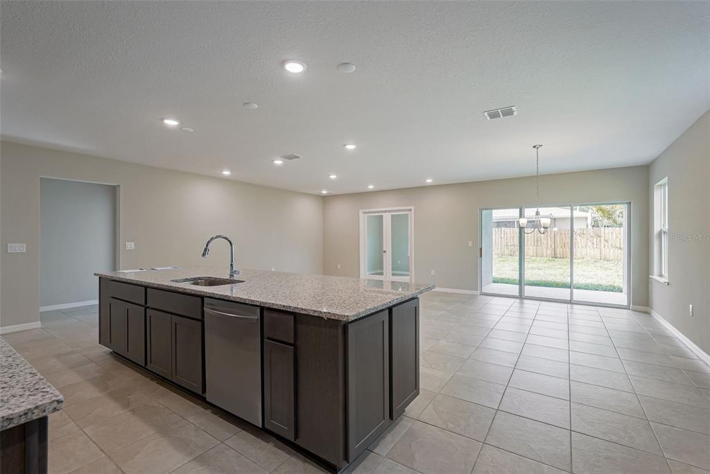 12899 Florida Avenue Astatula, FL 34705 - Photo 25 of 50 a view of a kitchen with a sink and chandelier