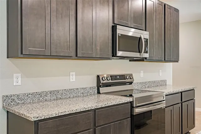 a kitchen with granite countertop stainless steel appliances granite countertop counter space a sink and cabinets