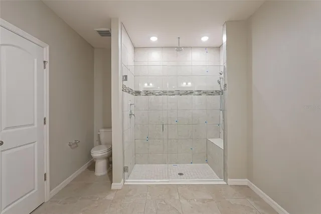 a view of a bathroom with toilet shower and a yard