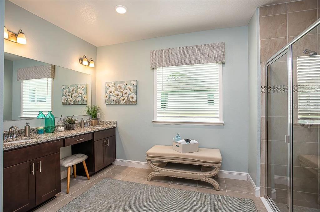 12899 Florida Avenue Astatula, FL 34705 - Photo 10 of 50 a spacious bathroom with double vanity and a mirror