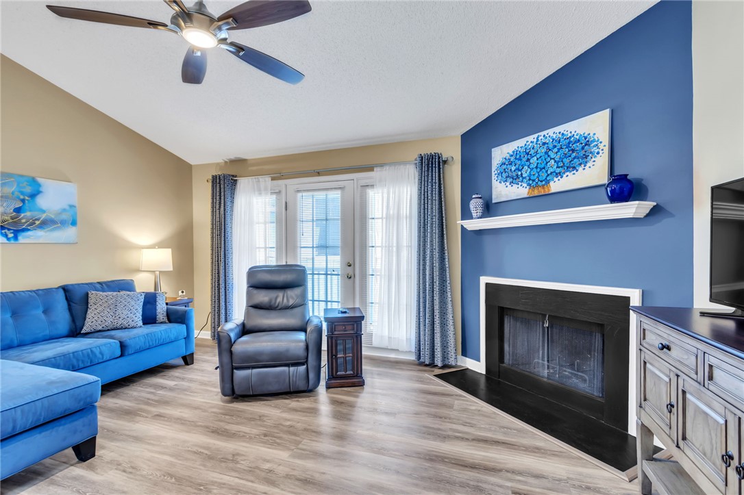 706 Pelham Square Way Greer, SC 29650 - Photo 3 of 20 This living room features vaulted ceilings, a cozy fireplace, and beautiful flooring, perfect for relaxation.